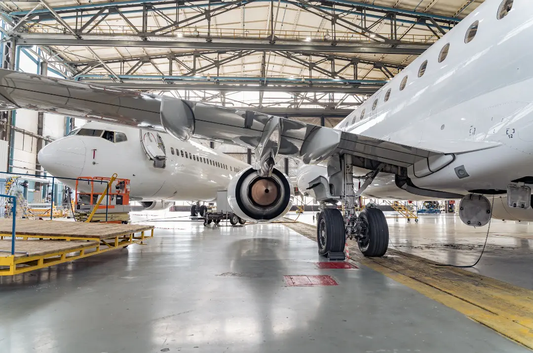 A large airplane parked in an airport hangar.