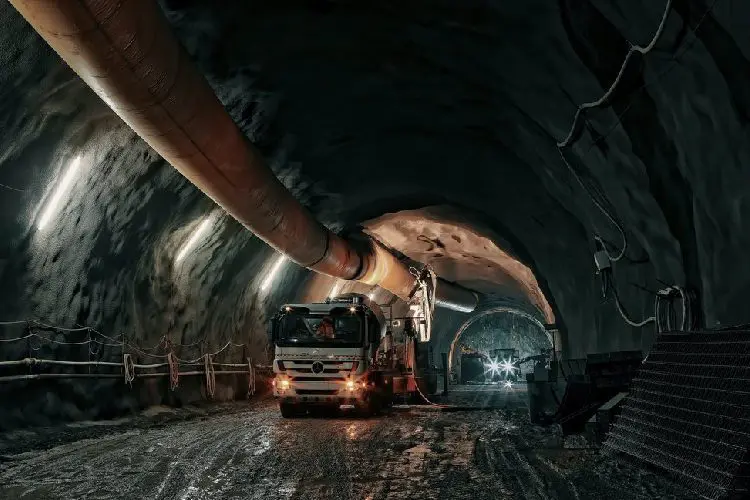 A truck is driving through an underground tunnel.