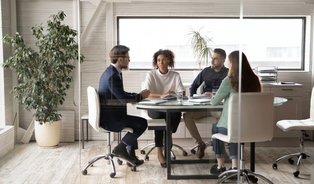 Business meeting around a glass table.