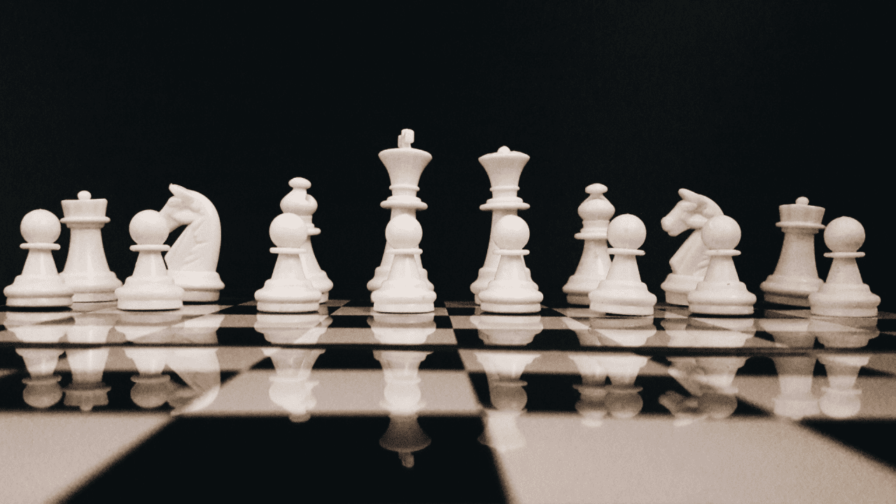 Chess pieces on a black and white board.