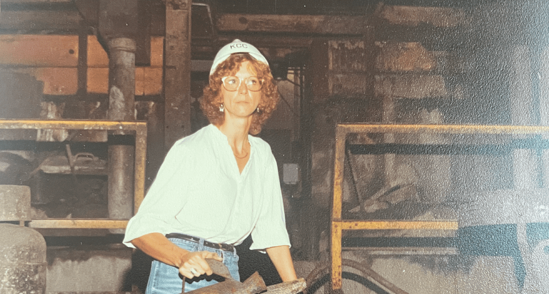 Woman in a factory working with metal.