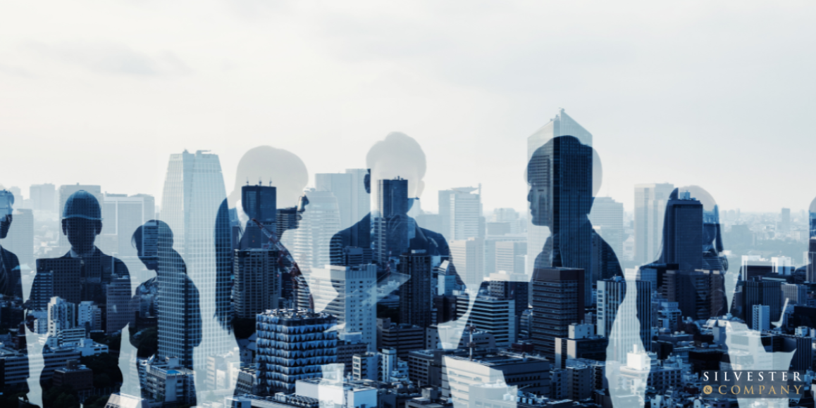 Silhouettes of people in a city skyline.