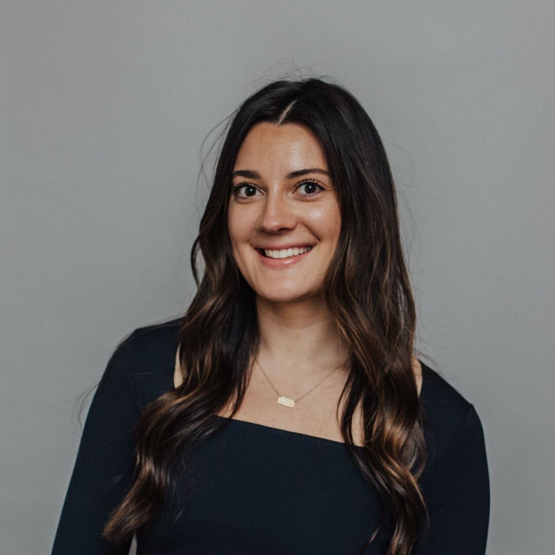 Woman with long brown hair smiling.