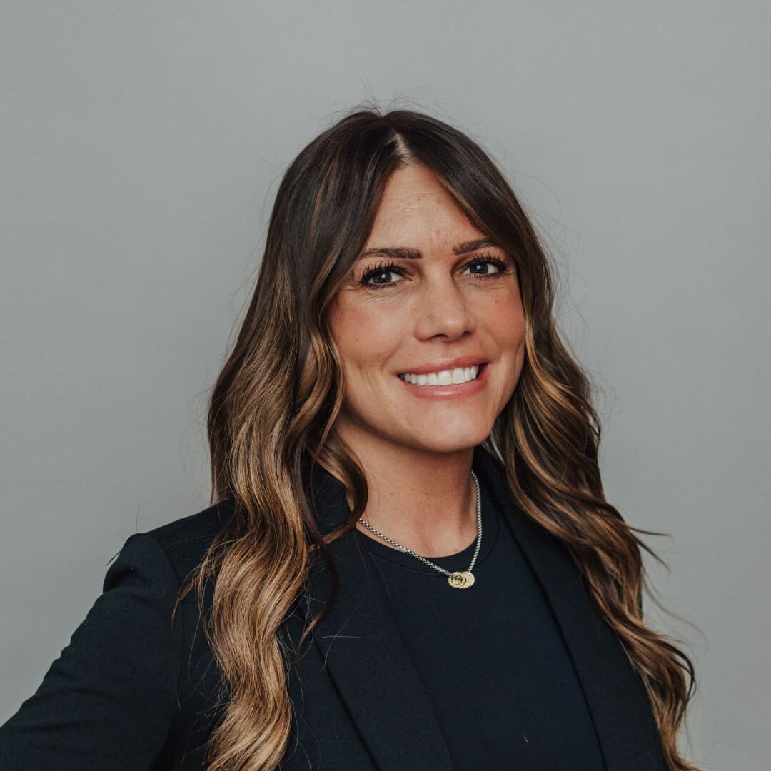 Smiling woman with long brown hair.