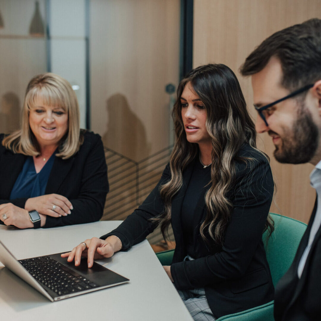 Three businesspeople in a meeting.