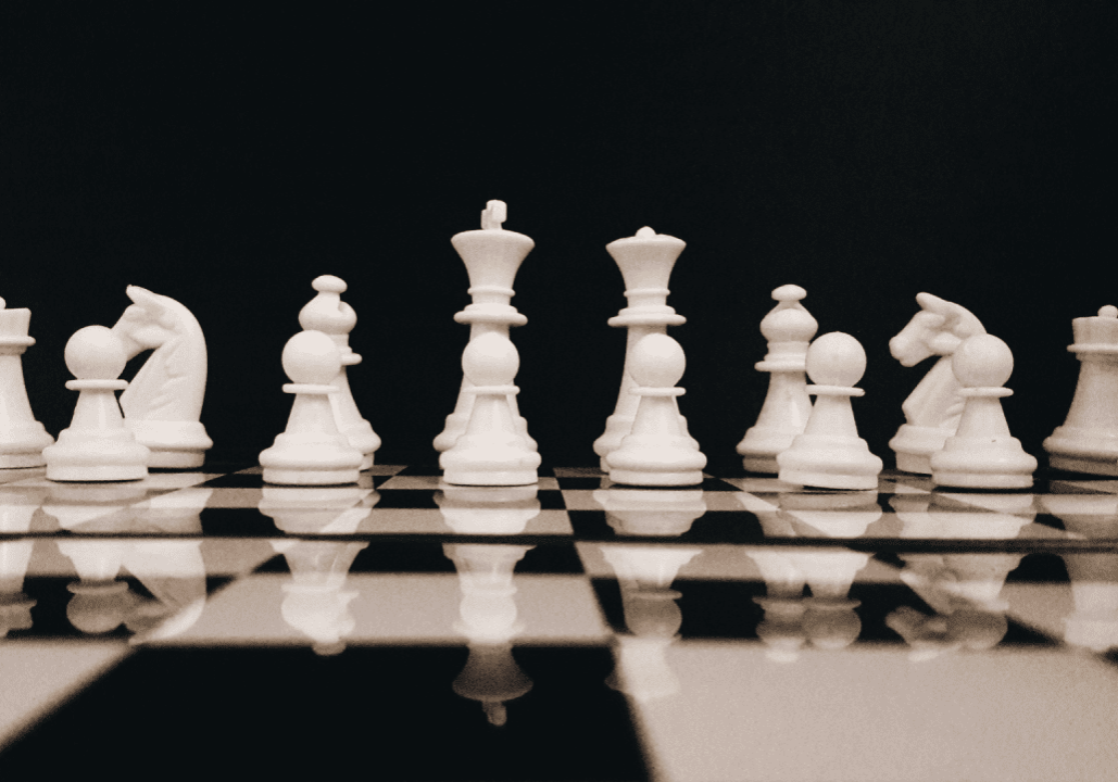 Chess pieces on a black and white board.