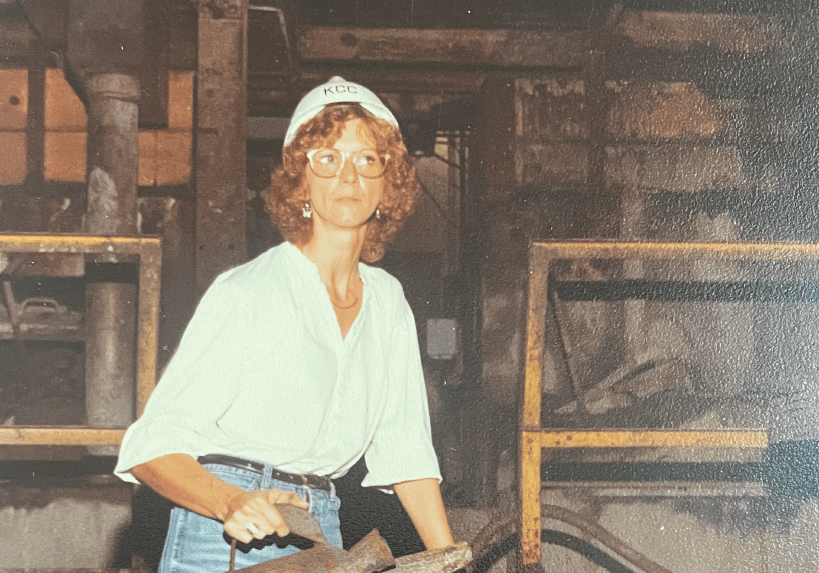 Woman in a factory working with metal.